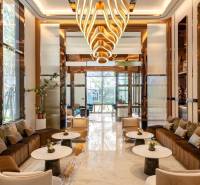 Luxurious interior with an elegant chandelier and comfortable seating for apartment construction.