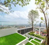 Rooftop terrace with a view of the city of Pattaya and residential buildings.
