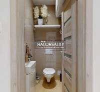 A small bathroom with a toilet and a sink in a 3-room apartment.