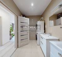 A bathroom in a 3-room apartment with two sinks and a washing machine.