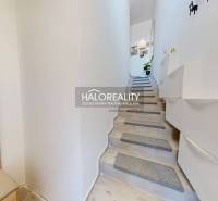 Interior of a 3-room apartment with a modern staircase and storage space.