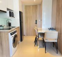 Kitchen in a 2-room apartment with a dining table and appliances.