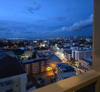 Evening view of the illuminated Pattaya skyline from a studio apartment.