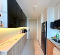 A kitchen in a 3-room apartment with modern equipment and a light floor.