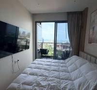 Bedroom in a 3-room apartment with a view, comfortable bed, and TV.
