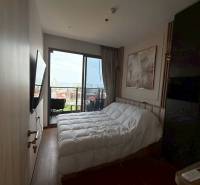 Bedroom with a bed and a view, 3-room apartment with a balcony.