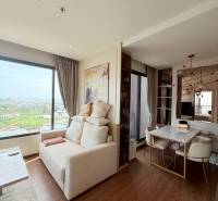 Living room in a three-room apartment, light walls, large window, dining table.