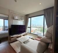 Living room in a 3-room apartment with a view and a large TV.