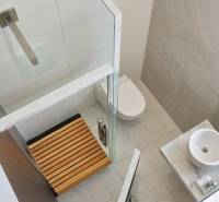 Bathroom in a 3-room apartment with a toilet, shower, and sink.
