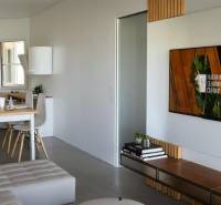 Living room in a 3-room apartment with a sofa, dining table, and television.