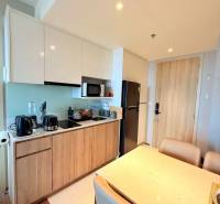 A kitchen in a 3-room apartment with wooden furniture and modern appliances.
