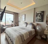 A bright bedroom with a large bed and a view in a 3-room apartment.