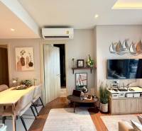 Living room of a 3-room apartment furnished with a table, chairs, and wall decorations.