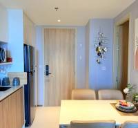 Dining area in a 3-room apartment with a dining table and a built-in kitchenette.
