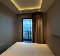 Bedroom with built-in lighting and a view of the balcony, 3-room apartment.