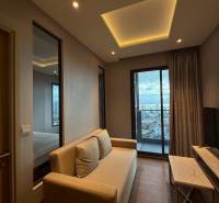Living room in a 3-room apartment with a sofa, television, and a view of the city.