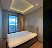 Bedroom in a 3-room apartment with a bed, built-in wardrobe, and curtains by the window.