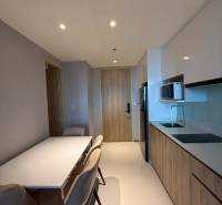 A kitchen in a 3-room apartment with a dining area and built-in appliances.