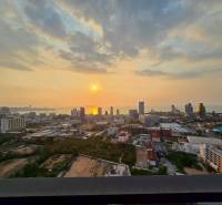 View from a 3-bedroom apartment in Pattaya of the sunset over the city and the sea.