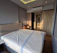Bedroom in a 3-room apartment with a double bed and air conditioning, wooden floor.