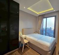 Bedroom in a 3-room apartment with a large window and wooden floor.