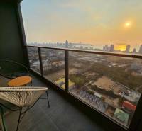 A balcony with a view of the city of Pattaya and the sunset from a 3-bedroom apartment.