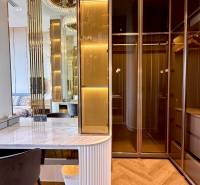 A wardrobe with lighting, a mirror, and a table in a 4-room apartment.