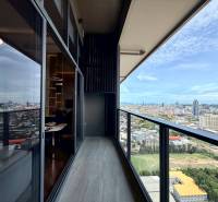 View from a 4-bedroom apartment in Pattaya. Balcony with glass railing and city panorama.