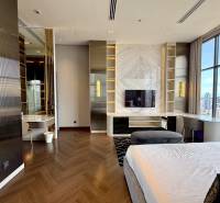 Luxury bedroom with a view, wooden floor, television, and desk in a 4-room apartment.