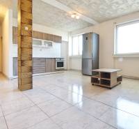 Spacious kitchen with built-in appliances in a 2-room apartment, tiles, large windows.