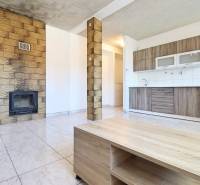 A spacious kitchen with a fireplace and furniture in a 2-room apartment.