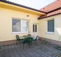 Yellow facade with a terrace and green furniture, 2-room apartment, Tulipánova, Trnava.