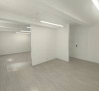 A bright interior with white walls and flooring in commercial spaces.