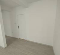 Commercial premises with white walls and wooden flooring.