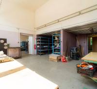 Interior of warehouses and halls with shelves and workbenches, equipped with various tools and materials.