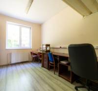 Office room with desks, chairs, and a cabinet in warehouses and halls.