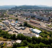Aerial view of Trenčín, Kasárenská Street and Warehouses and Halls, with mountains in the background.