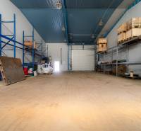Interior of warehouses and halls with storage racks and wooden pallets.