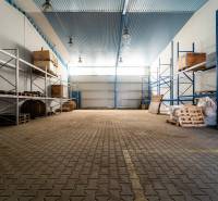 Warehouses and halls with shelves and pallets for material storage.