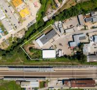 Aerial view of warehouses and halls in Trenčín on Kasárenská Street near the railway track.