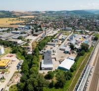 Aerial view of the industrial area on Kasárenská Street in Trenčín with warehouses and halls.