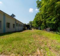 Production premises on Kasárenská Street in Trenčín surrounded by greenery and open space.