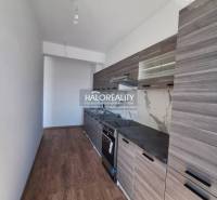 Kitchen in a 2-room apartment with a light floor design and modern equipment.