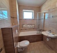Bathroom in a 2-room apartment with a bathtub, sink, and toilet.