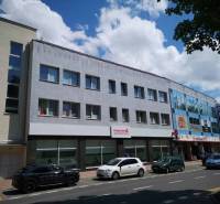 Commercial premises on 1. mája Street in Poprad with cars parked in front of the building.