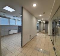 Glass doors, tiles, neutral walls, and lighting in commercial spaces.