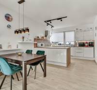 A kitchen with a dining table and chairs in a family house.