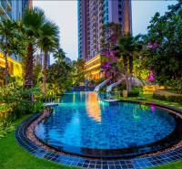 A pool with greenery during the construction of apartments in Pattaya.