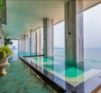 A swimming pool with a stunning sea view within the construction of apartments in Pattaya.