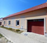 A family house in Trakovice with a sloped roof and two windows facing the street.
